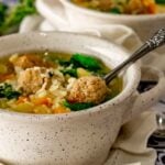 A bowl with handles with Wedding Soup made in the Instant Pot.