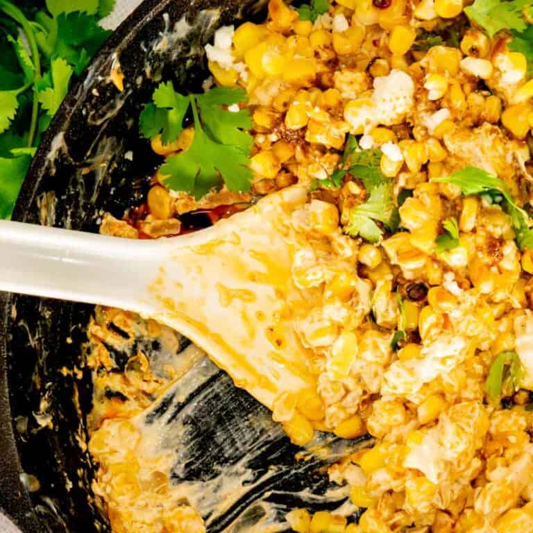 Mexican Street Corn Dip with a serving spoon.
