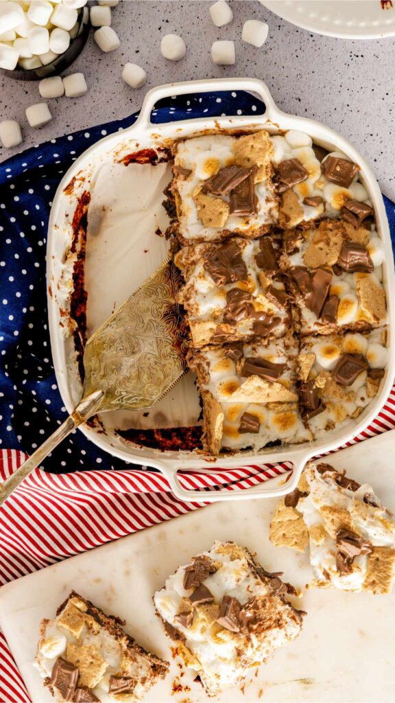 Cut squares of S mores Brownies in a white baking dish.