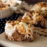 Three S'mores Brownies on a marble cutting board.