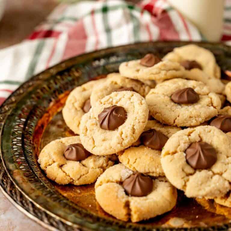 A plate of chocolate star cookies with chocolate stars pressed into the center of peanut butter cookies.