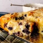 Blueberry Cream Cheese Coffee Cake cut into squares and served with a cake server.