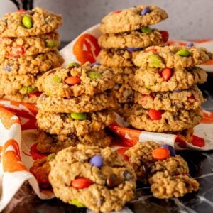 Stacks of Halloween Monster Cookies with Halloween colors.