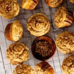 Pumpkin cheesecake muffins topped with brown sugar pecans.