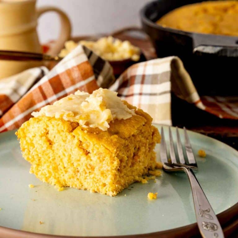 Honey butter smeared on top of a slice of sweet potato cornbread.