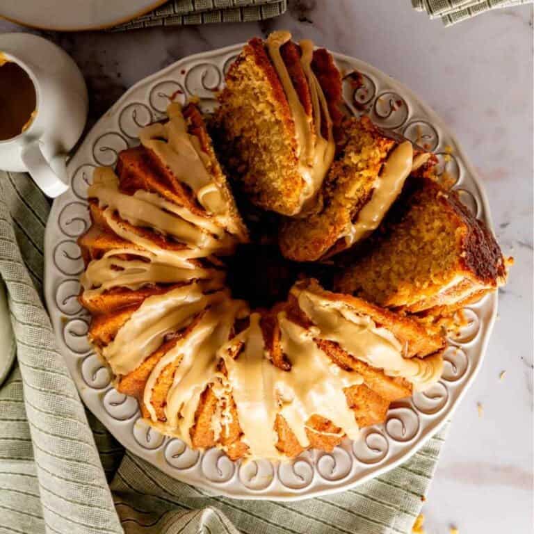Birdseye view of glazed and sliced brown sugar pound cake on decorative plate.
