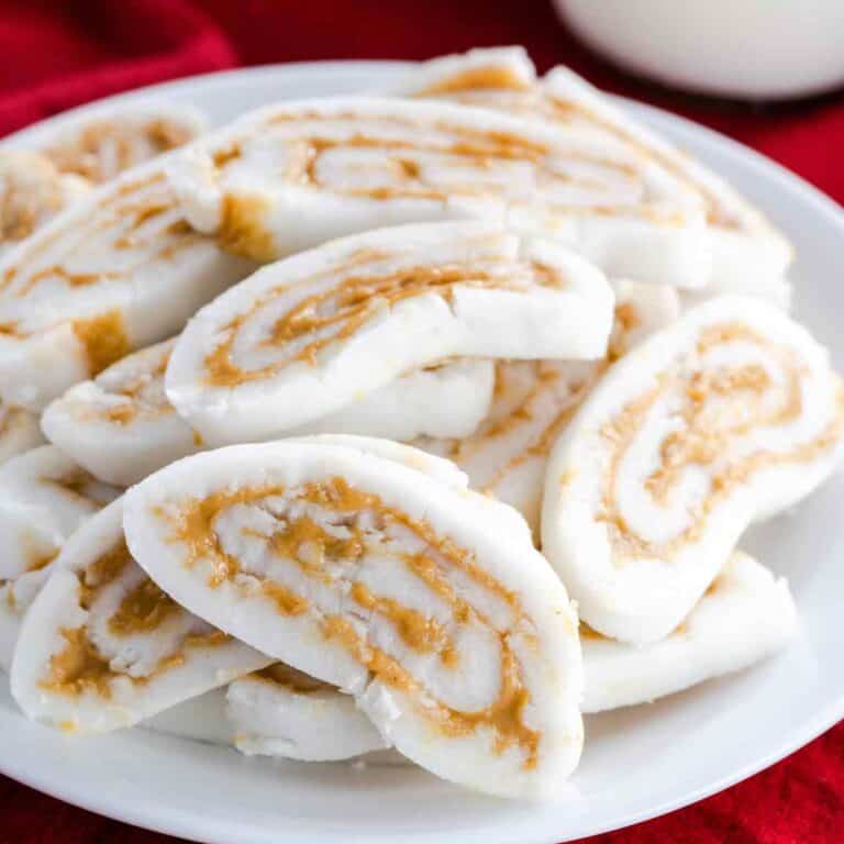 A plate of old fashioned potato candy with a glass of milk.