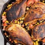 Cowboy Caviar with blackened chicken breasts in a cast iron skillet.
