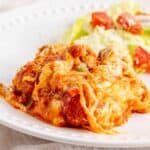 A serving of meatball sub bake topped with melted cheese.