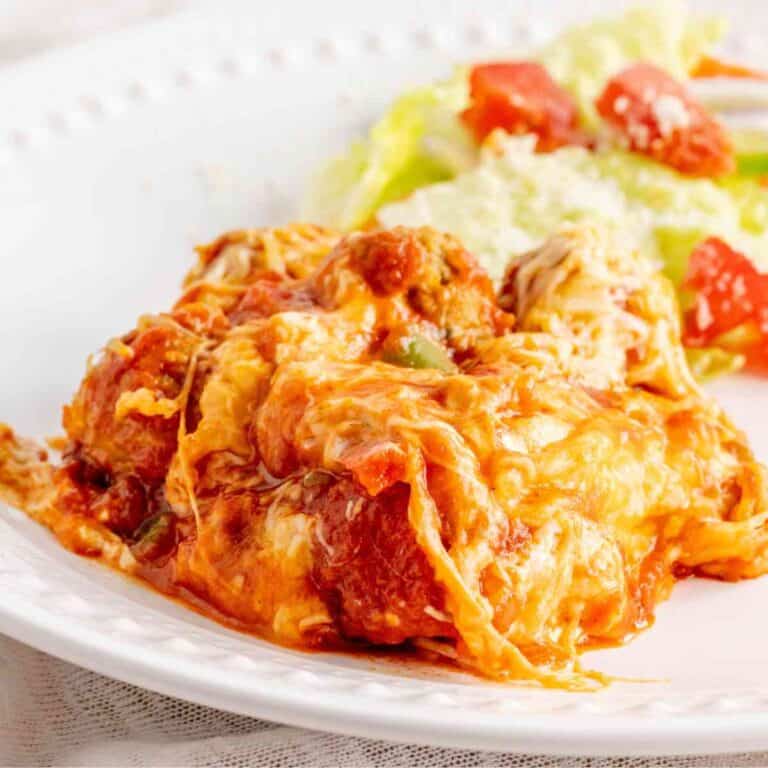 A serving of meatball sub bake topped with melted cheese.