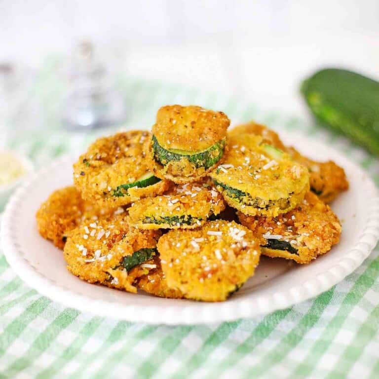 Fried Zucchini on a plate with a green napkin.