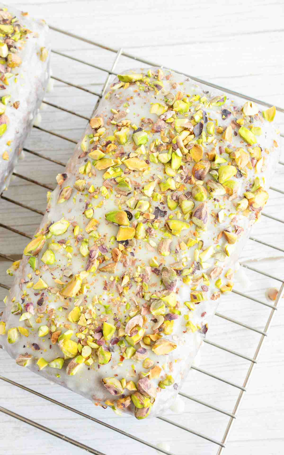 Overhead view of pistachio bread on wire rack.