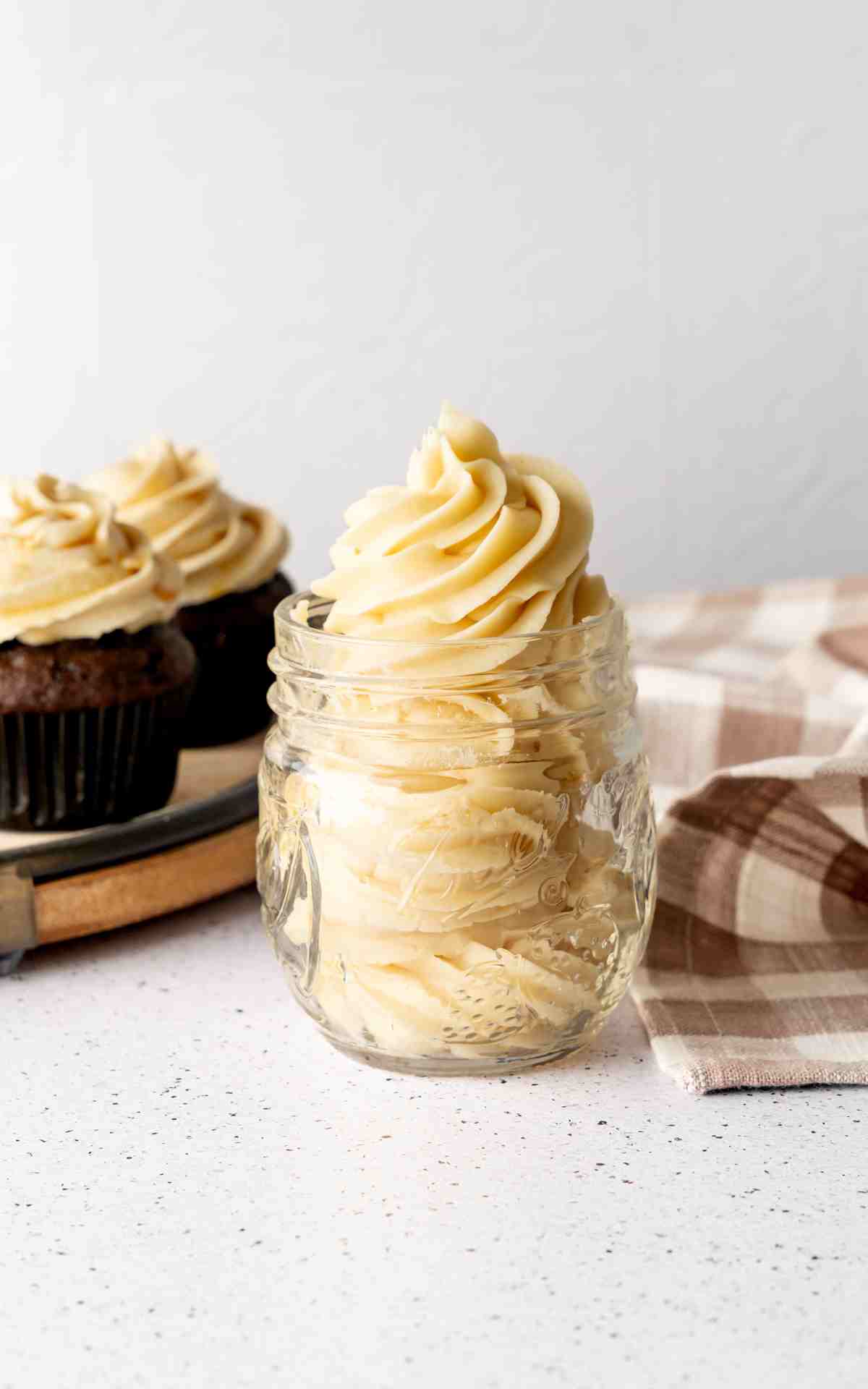Salted Caramel Frosting in a small mason jar.