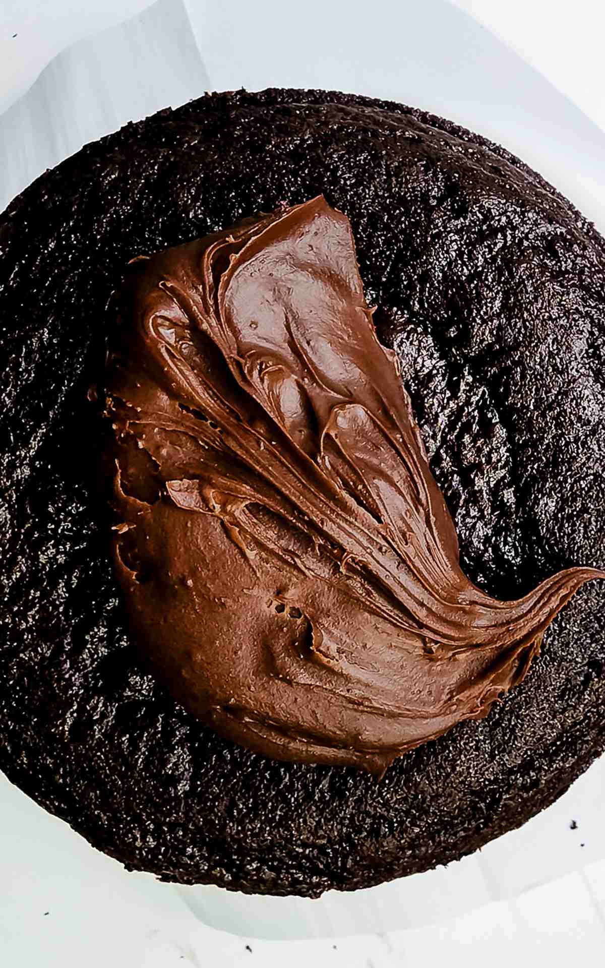 Top cake layer topped with chocolate buttercream.