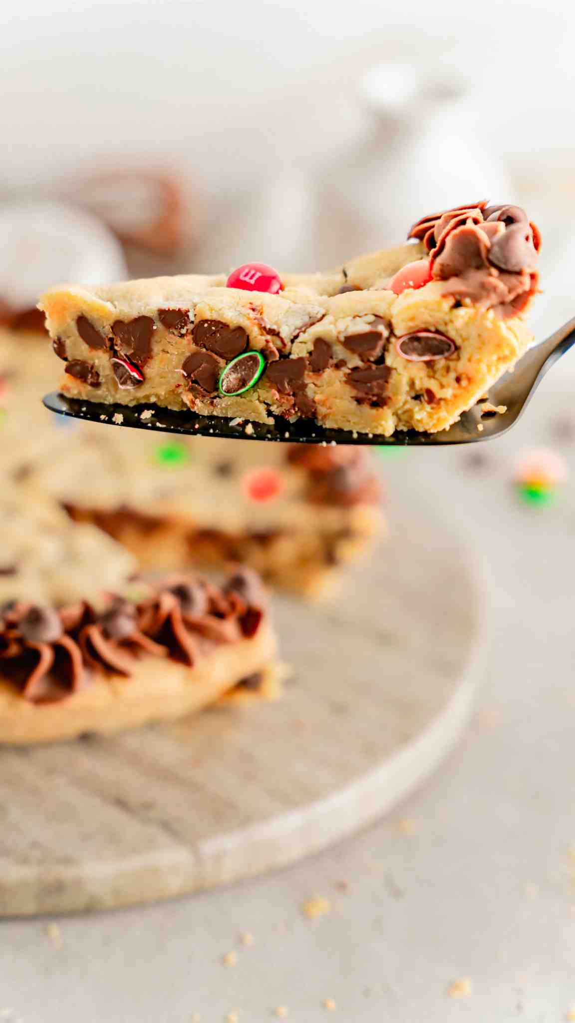 MM Cookie Cake slice help up on a pie server.