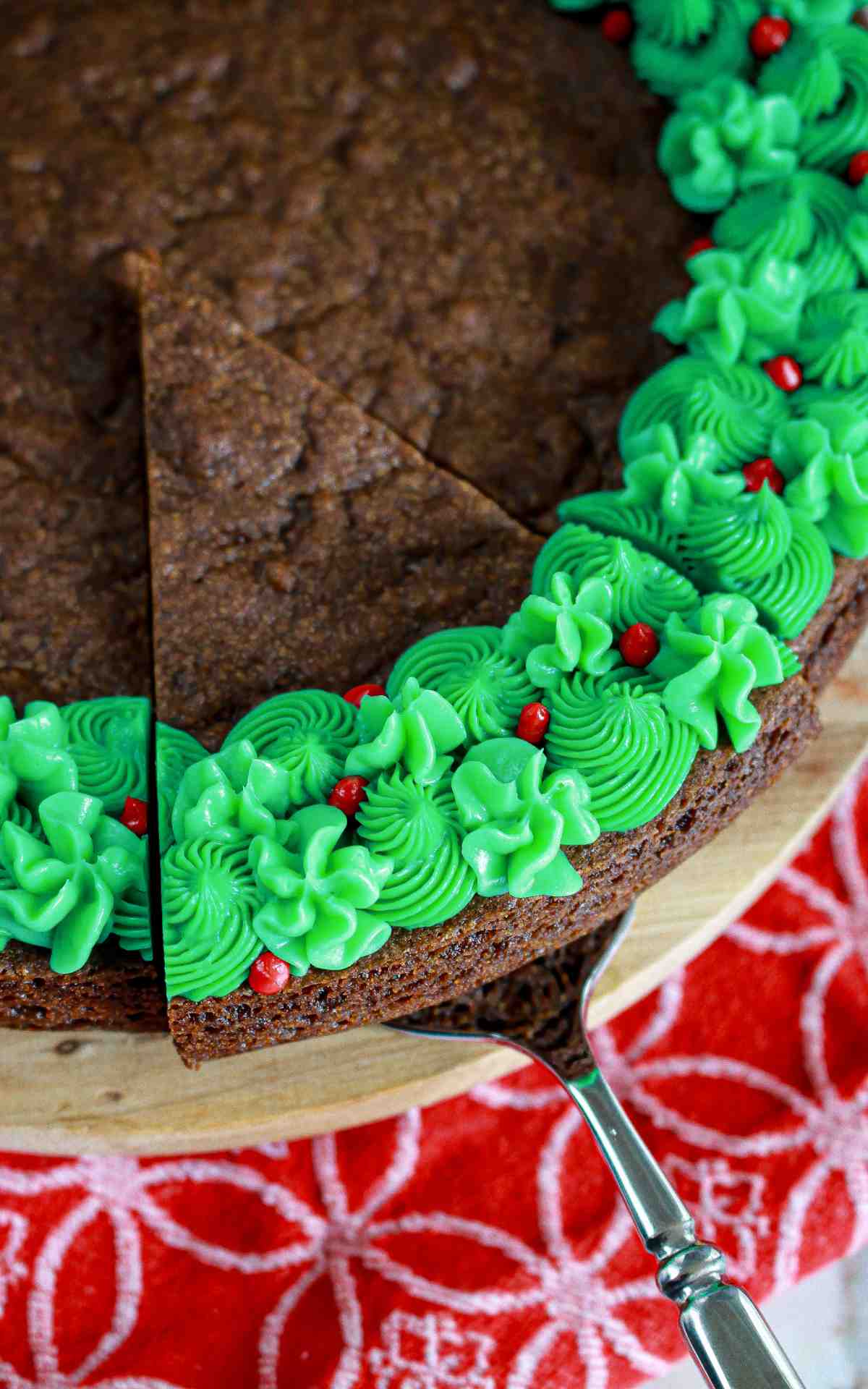 A cookie cake slice taken out of a whole cookie cake.