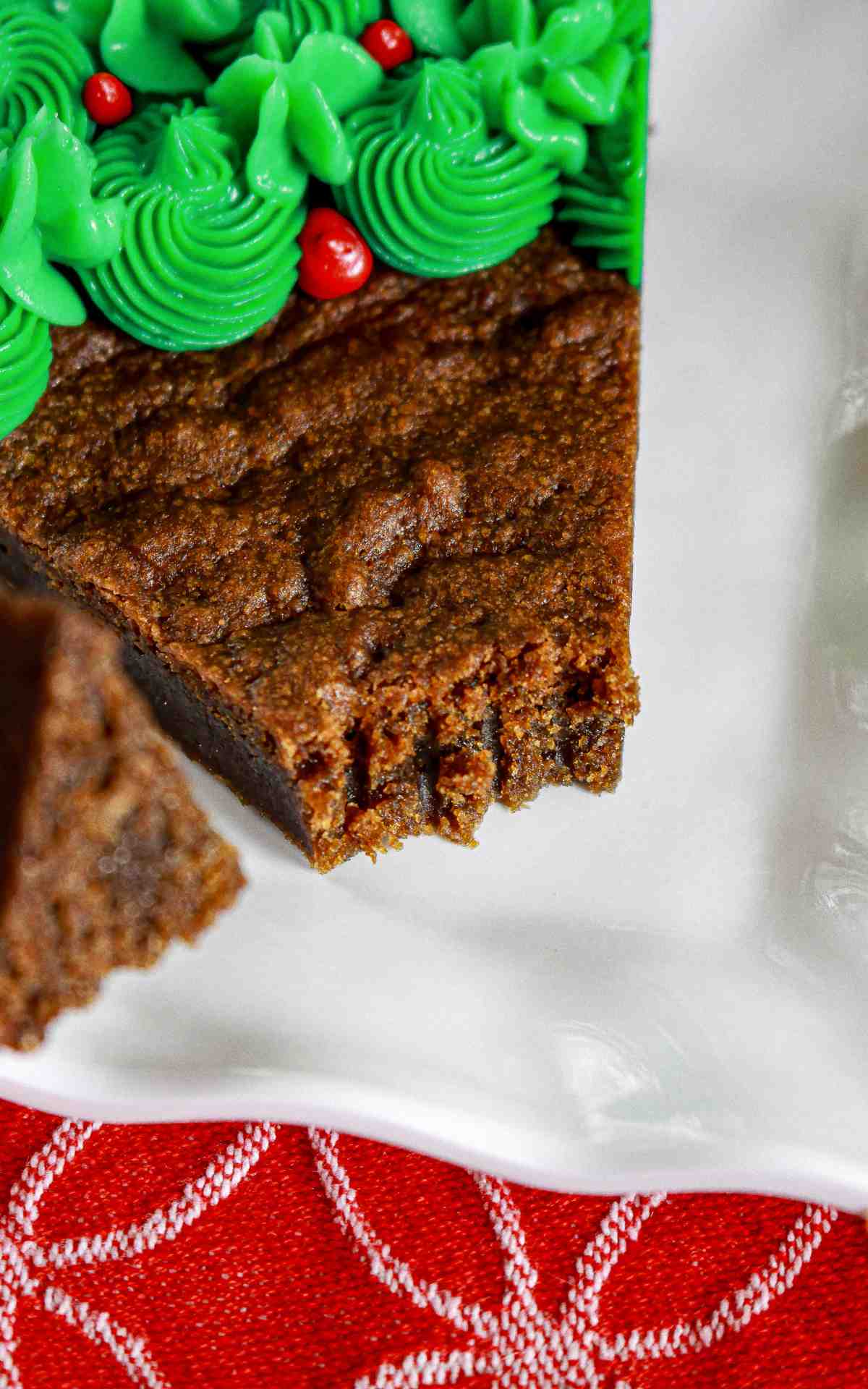 A piece of cookie cut off a cookie cake slice.
