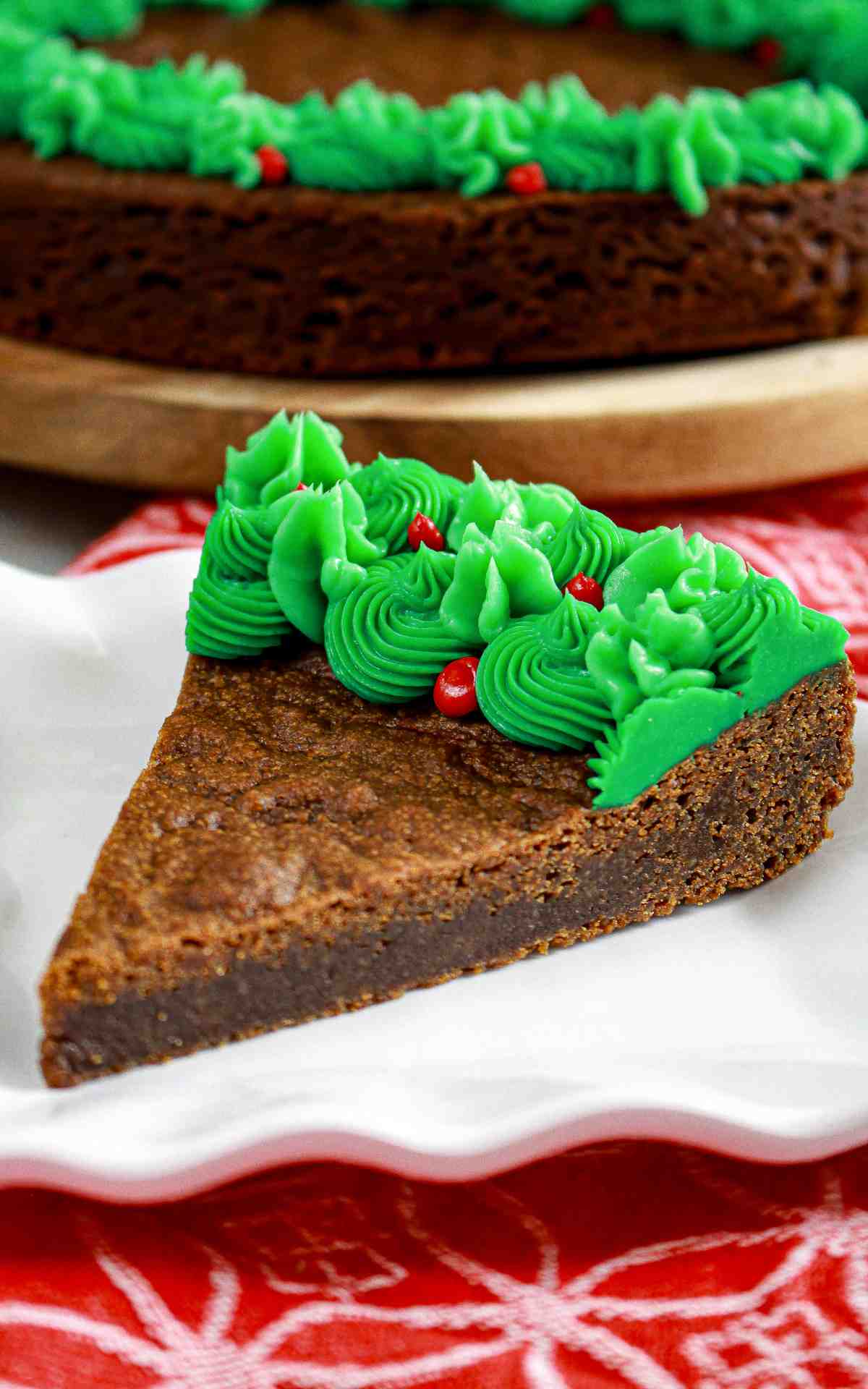 Slice of spiced cookie cake with green buttercream icing.