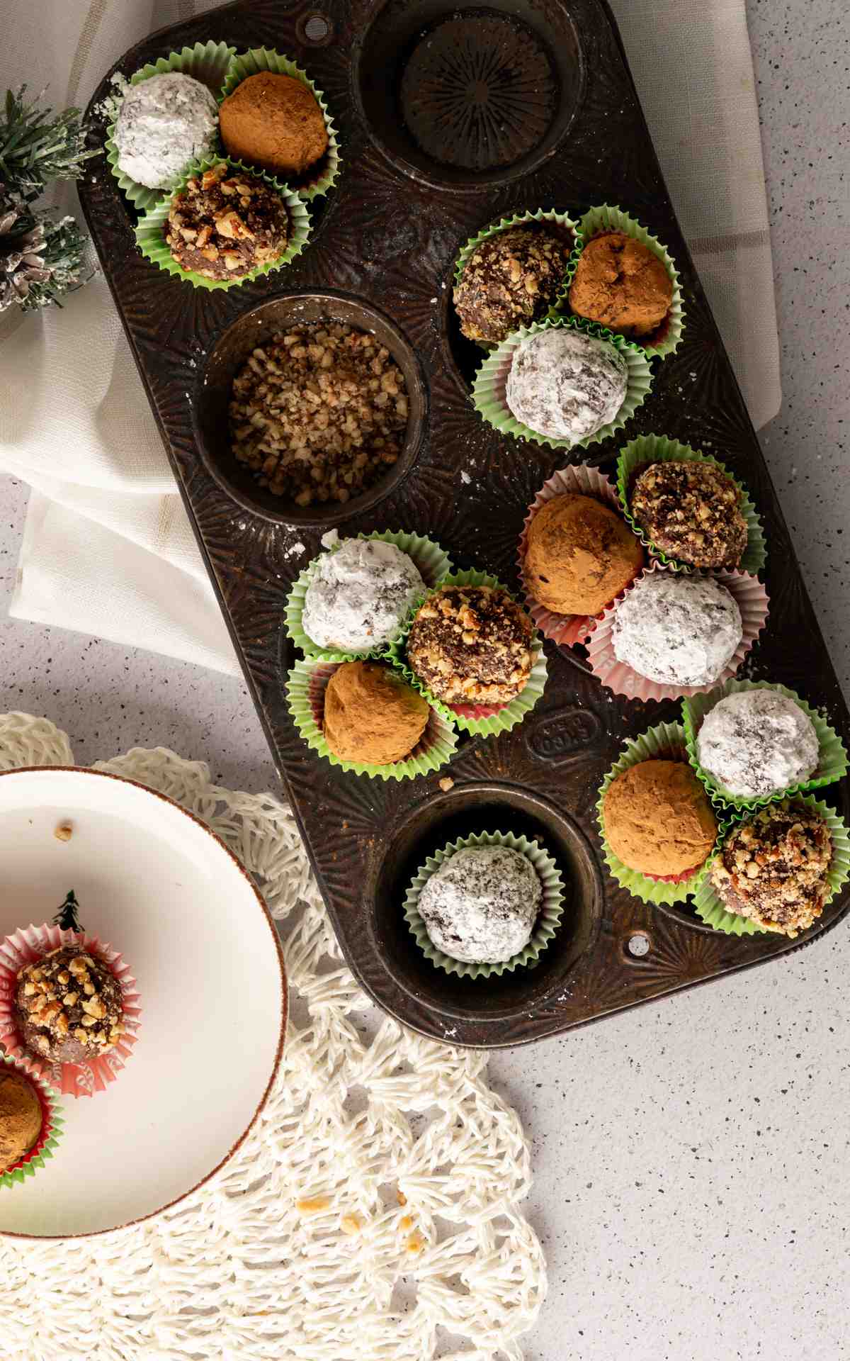 Overhead picture of coated rum balls in a cupcake pan.