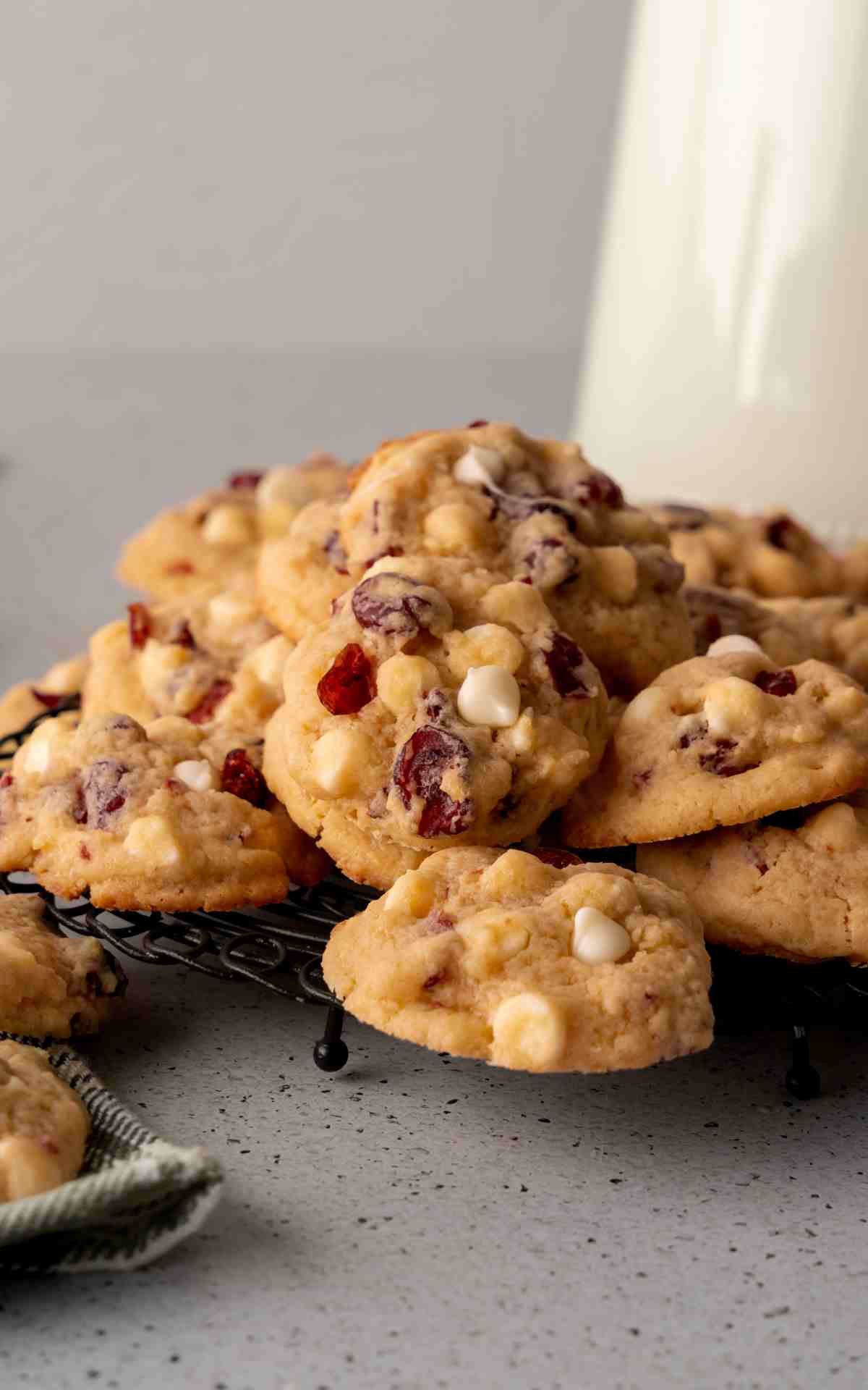 A cooling rack of white chocolate cranberry cookies.