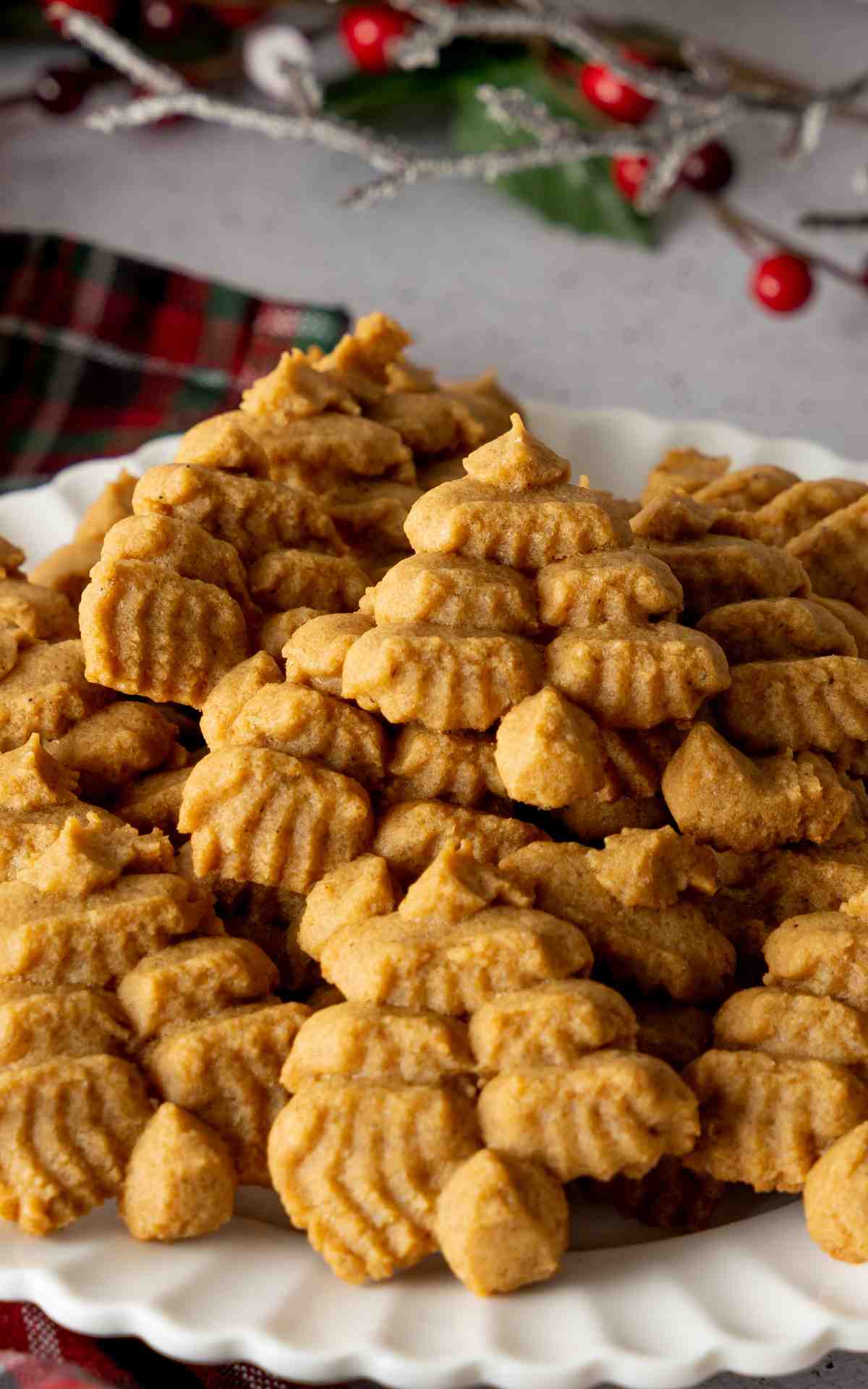Close up of Molasses Spritz Cookies with a Christmas linen napkin.