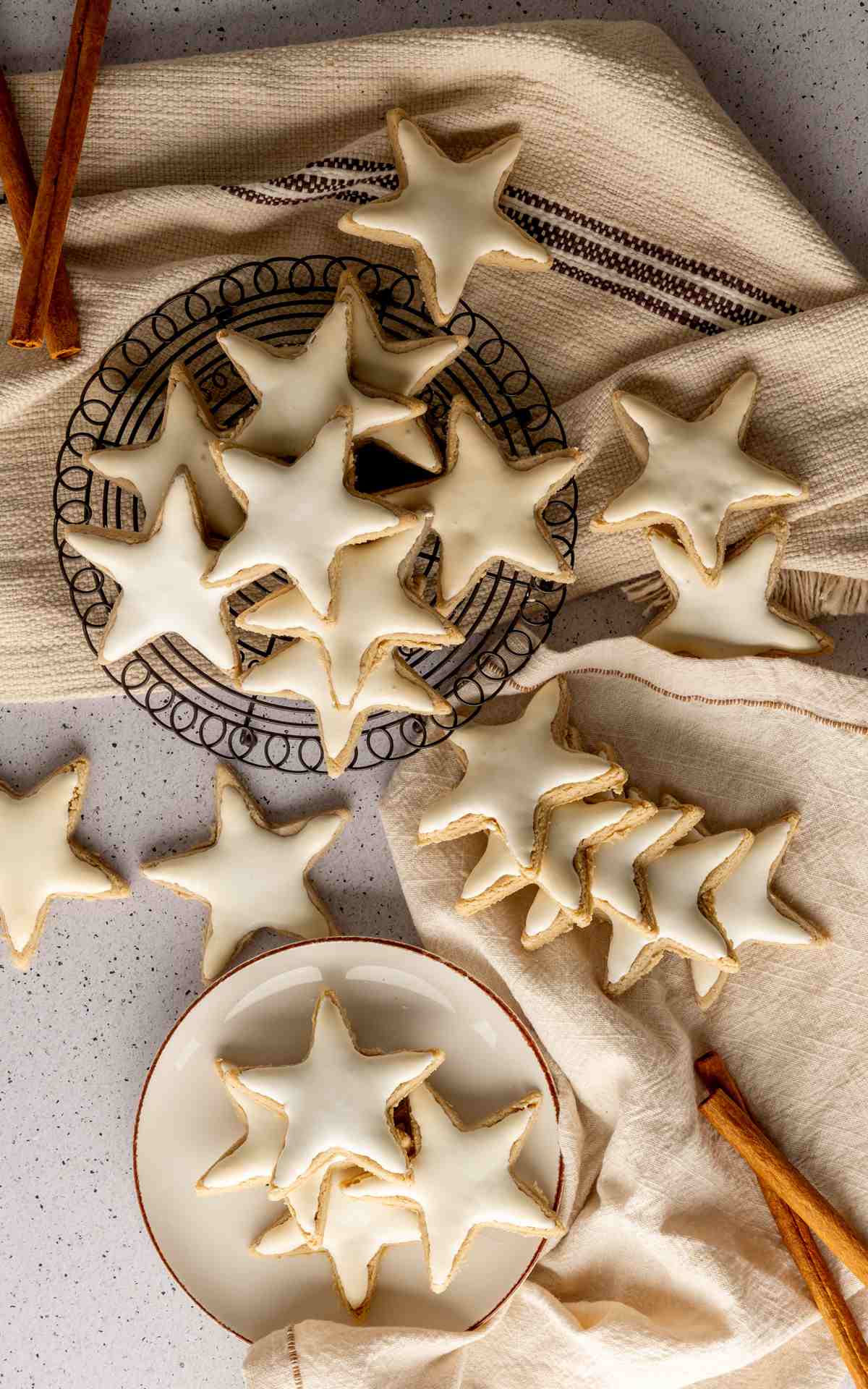 German Zimtsterne cookies on a wire rack and plate..