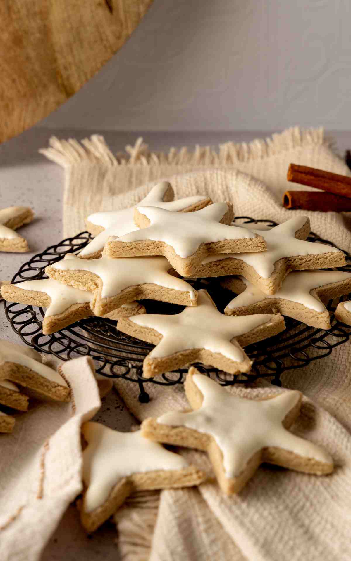 Zimtsterne German Cinnamon Star cookies stacked on a wire rack.