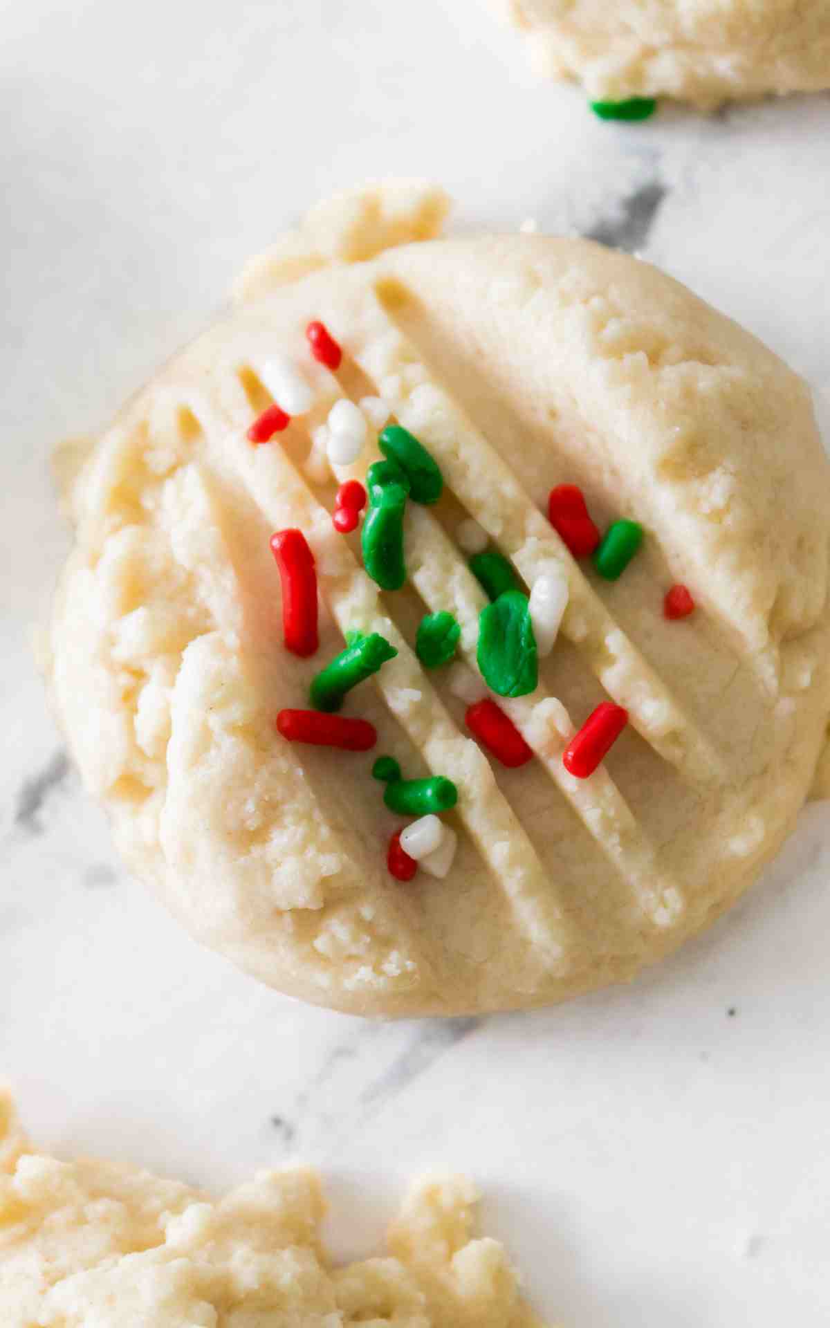 A whipped shortbread cookie on marble background.
