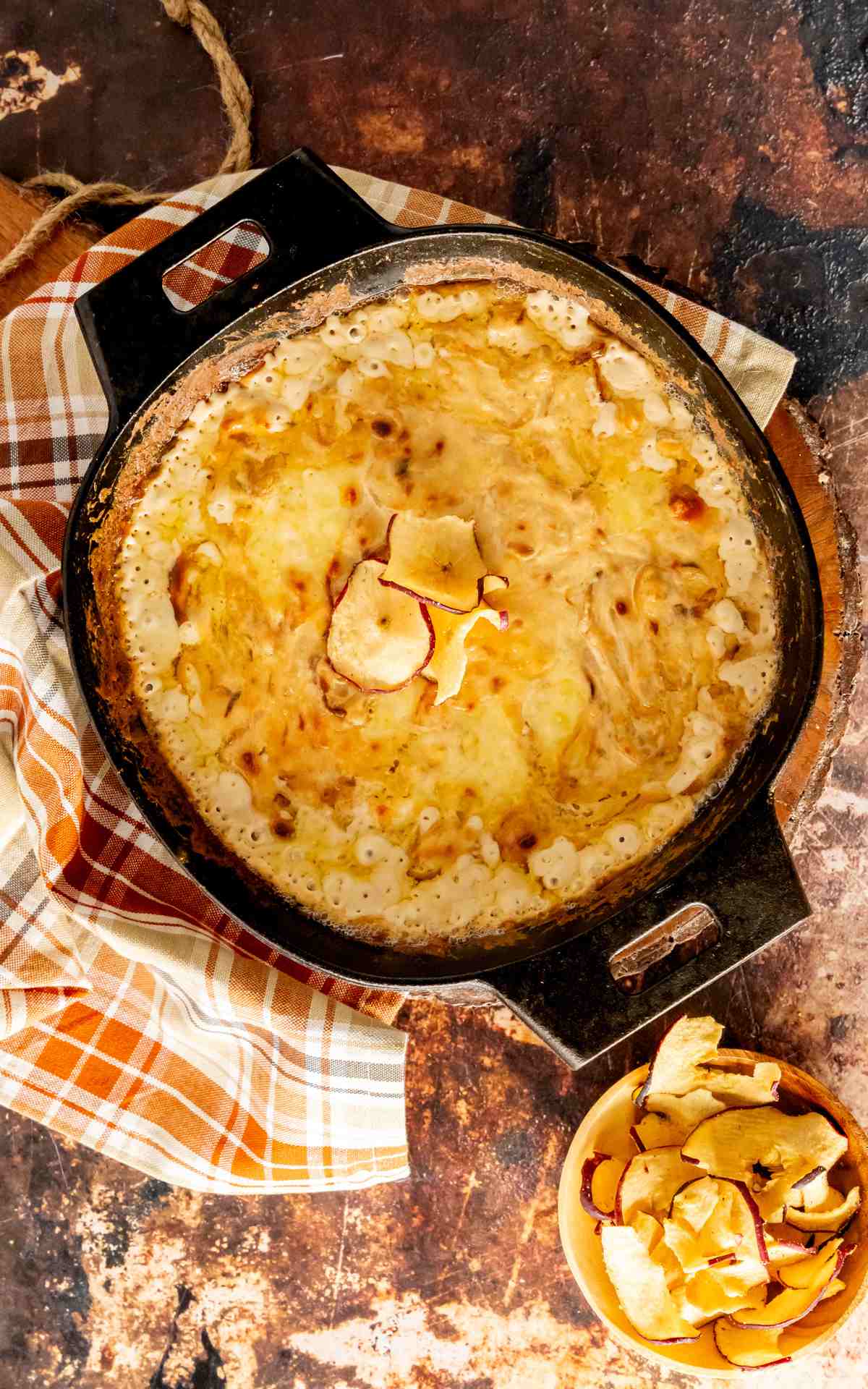 A cast iron skillet of Vidalia Onion Dip with swiss cheeses.