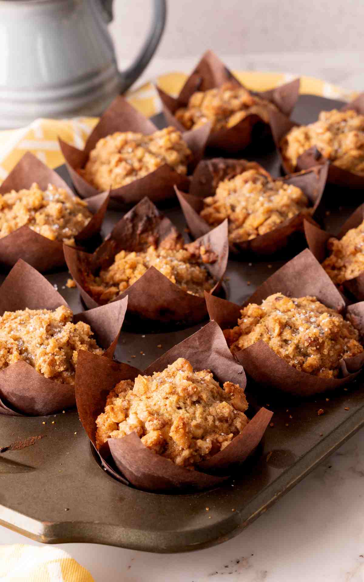 A muffin tin with twelve banana nut muffins.
