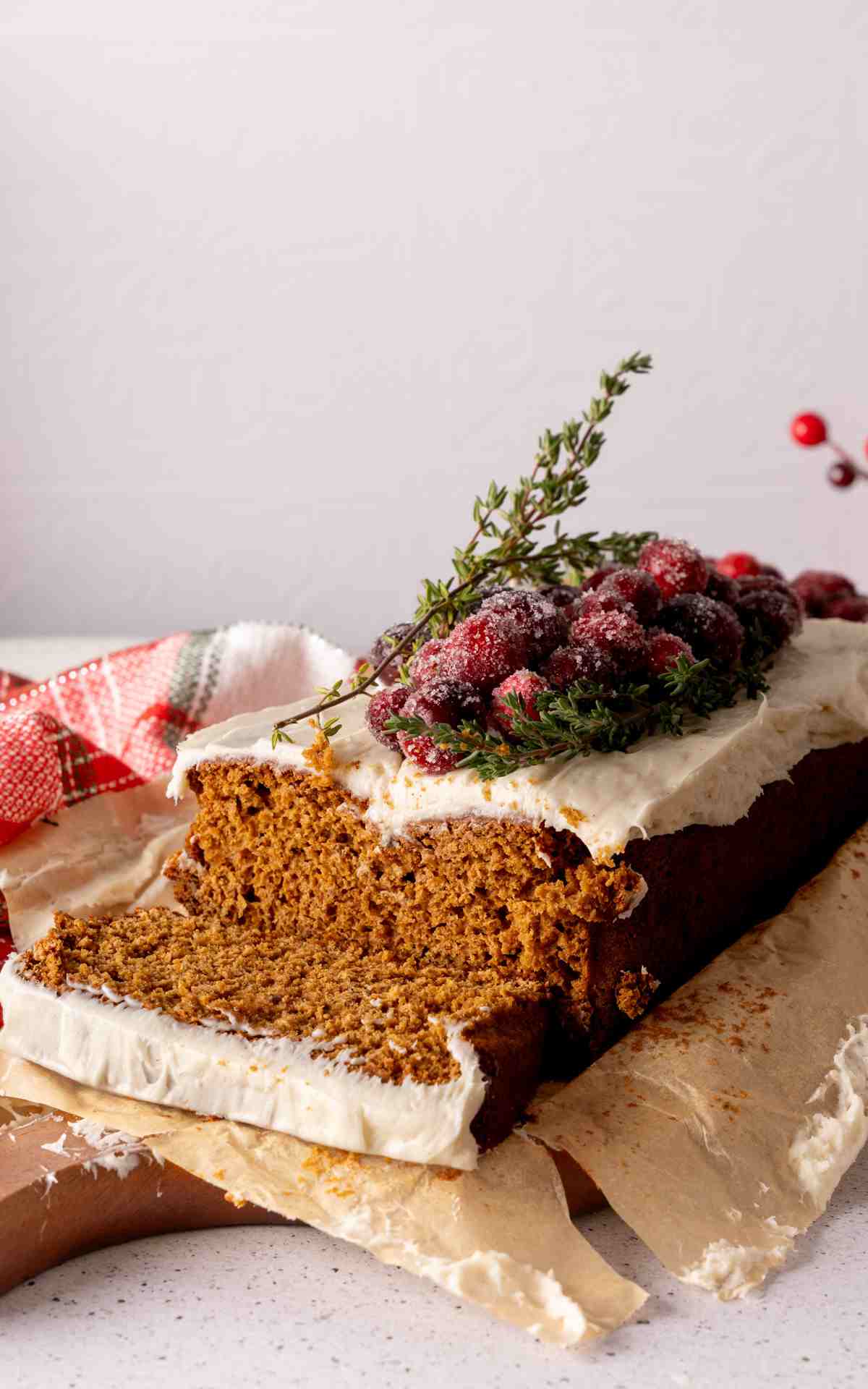 A slice cut from a gingerbread loaf made with cake ix on a serving board.