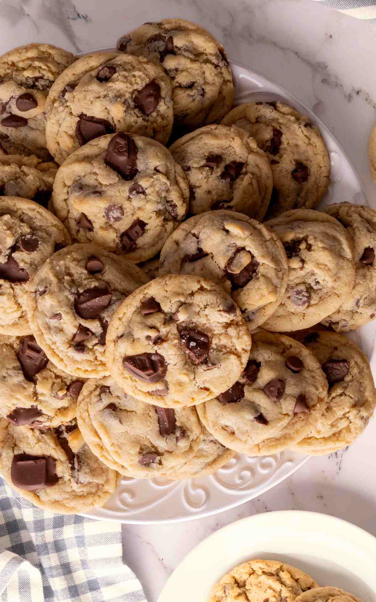 Eggless Chocolate Chip Cookies on a plate made with chocolate chips and chopped chocolate.