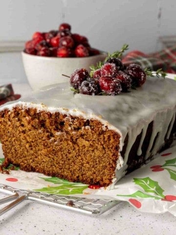 Gingerbread loaf cake iced with vanilla glaze featured image.