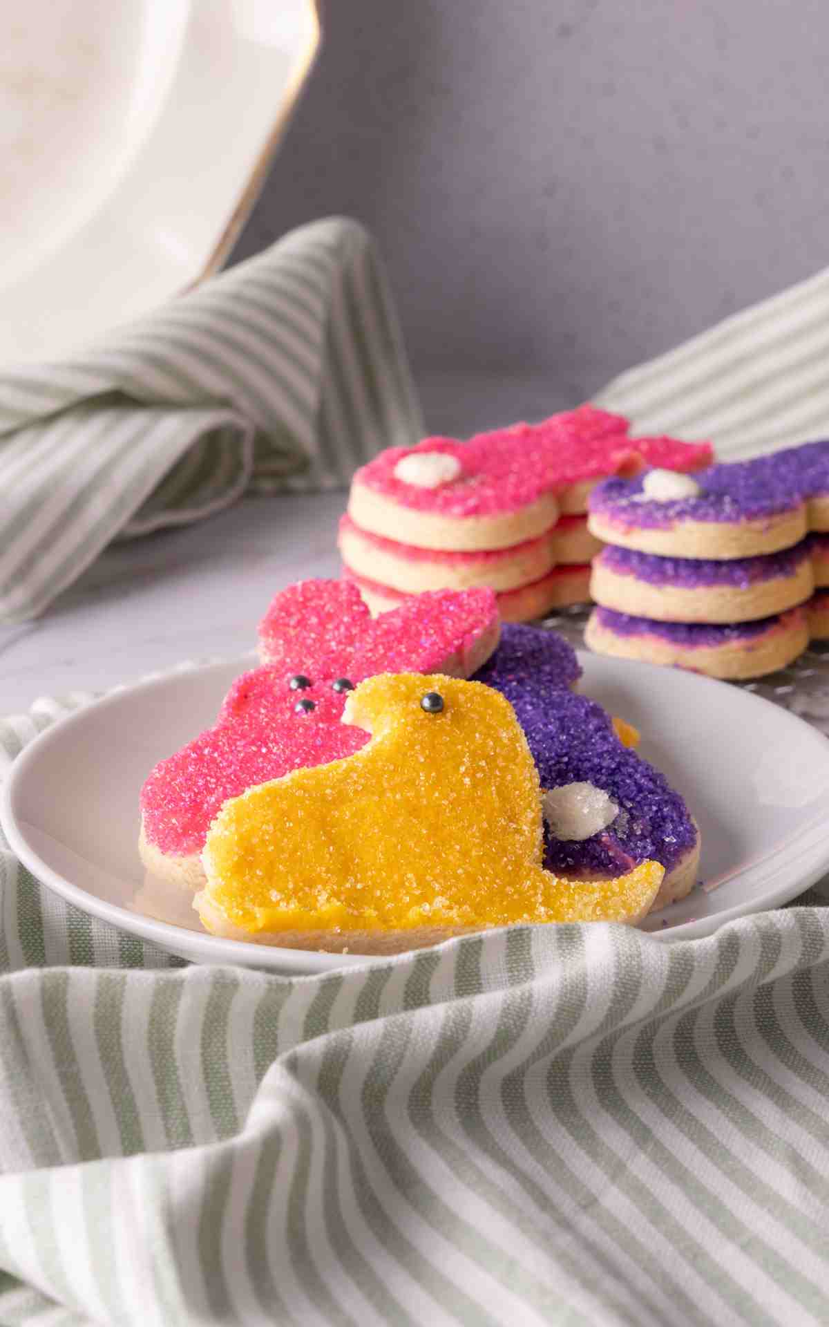 No spread sugar cookies cut into chicks and bunnies and decorated with sugar.