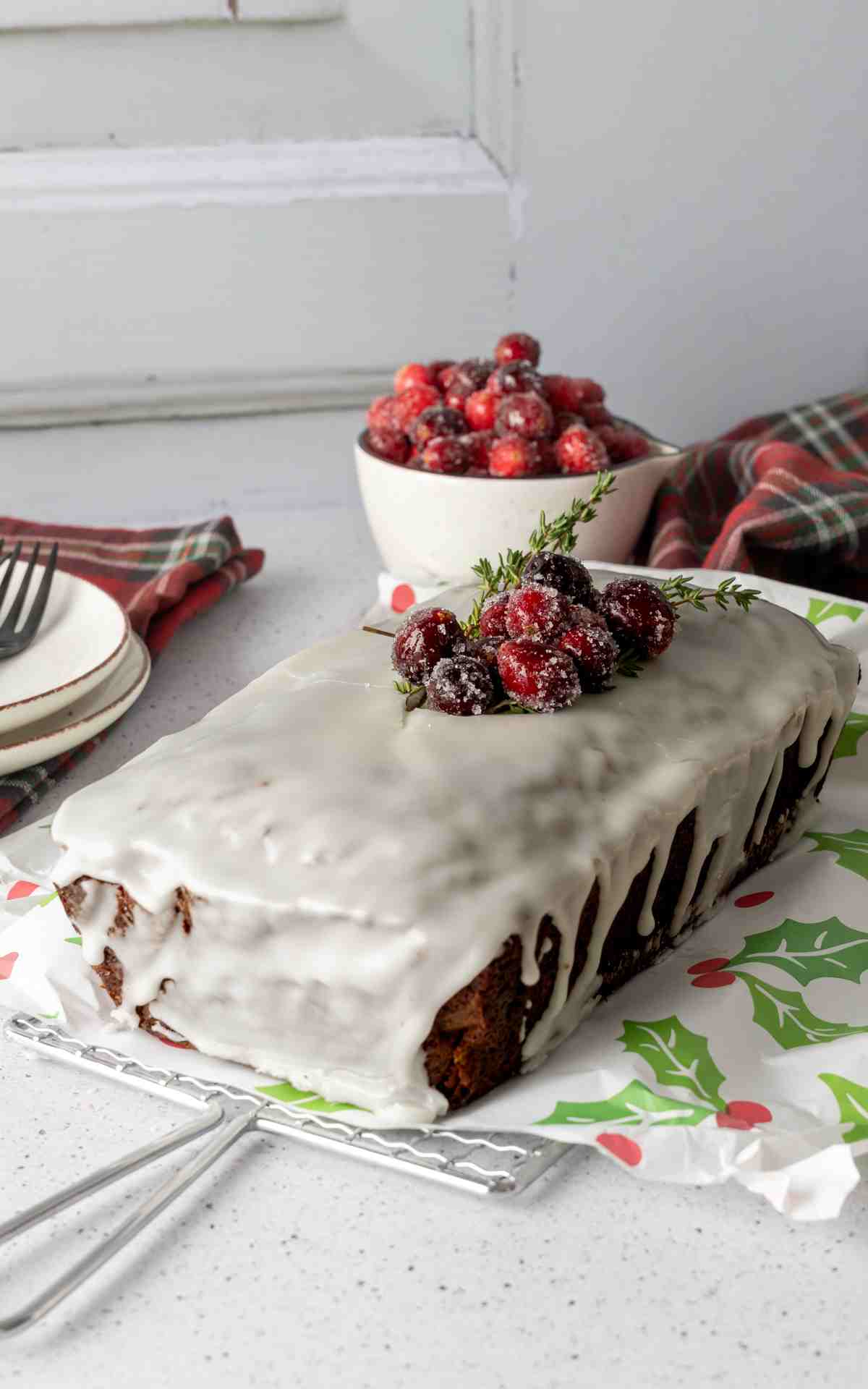 Old Fashioned Gingerbread Loaf with a vanilla glaze and cranberries on top.