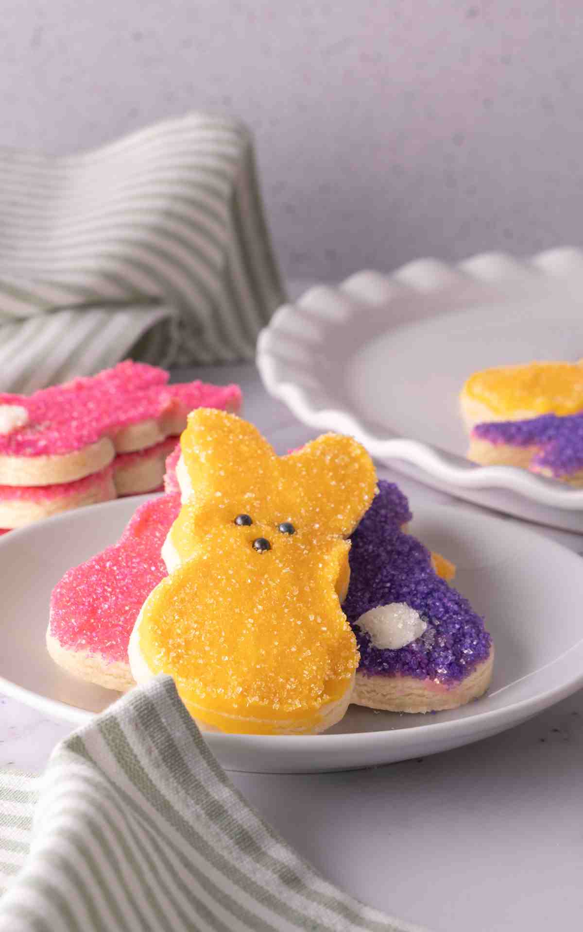 Soft frosted cut out sugar cookies like bunnies with colored sanding sugar.