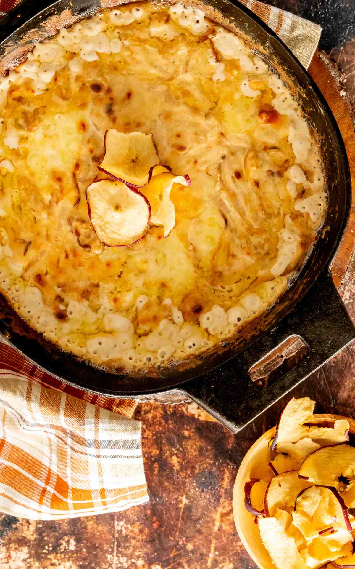 Vidalia Cheese Dip in a cast iron pan with dehydrated apple slices.