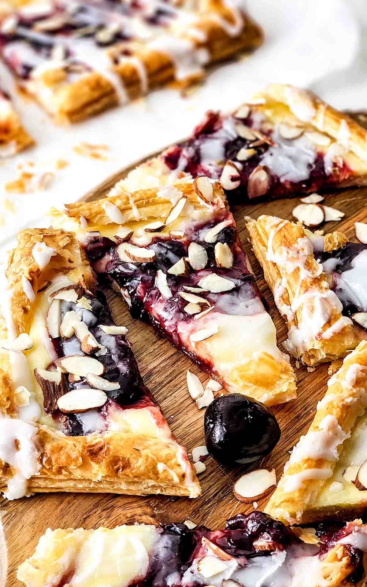 Cherry cheese danish slices topped with almond.