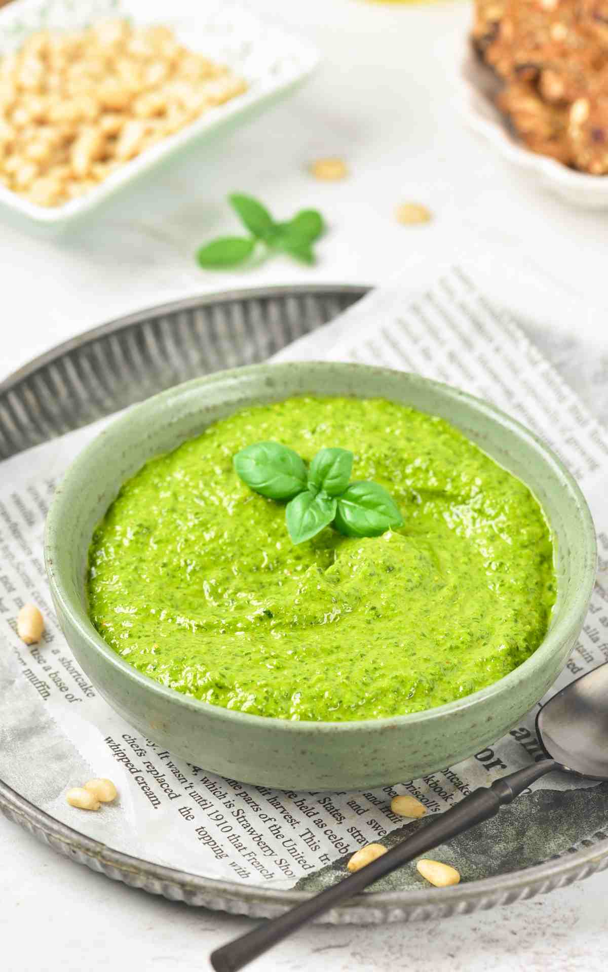Classic basil pesto recipe in a bowl with a serving spoon.