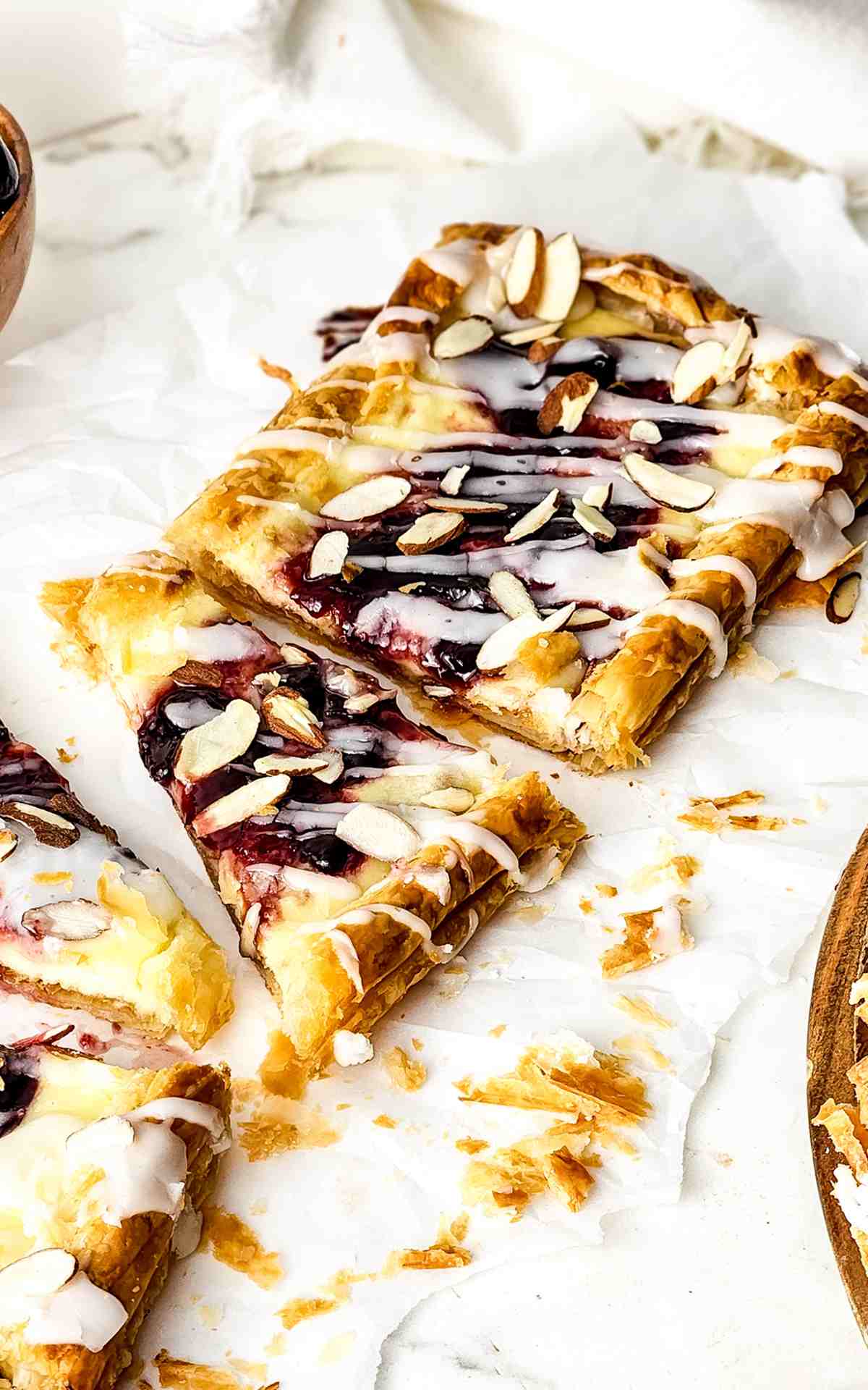 Sliced cherry cheese danish slic.ed into triangles