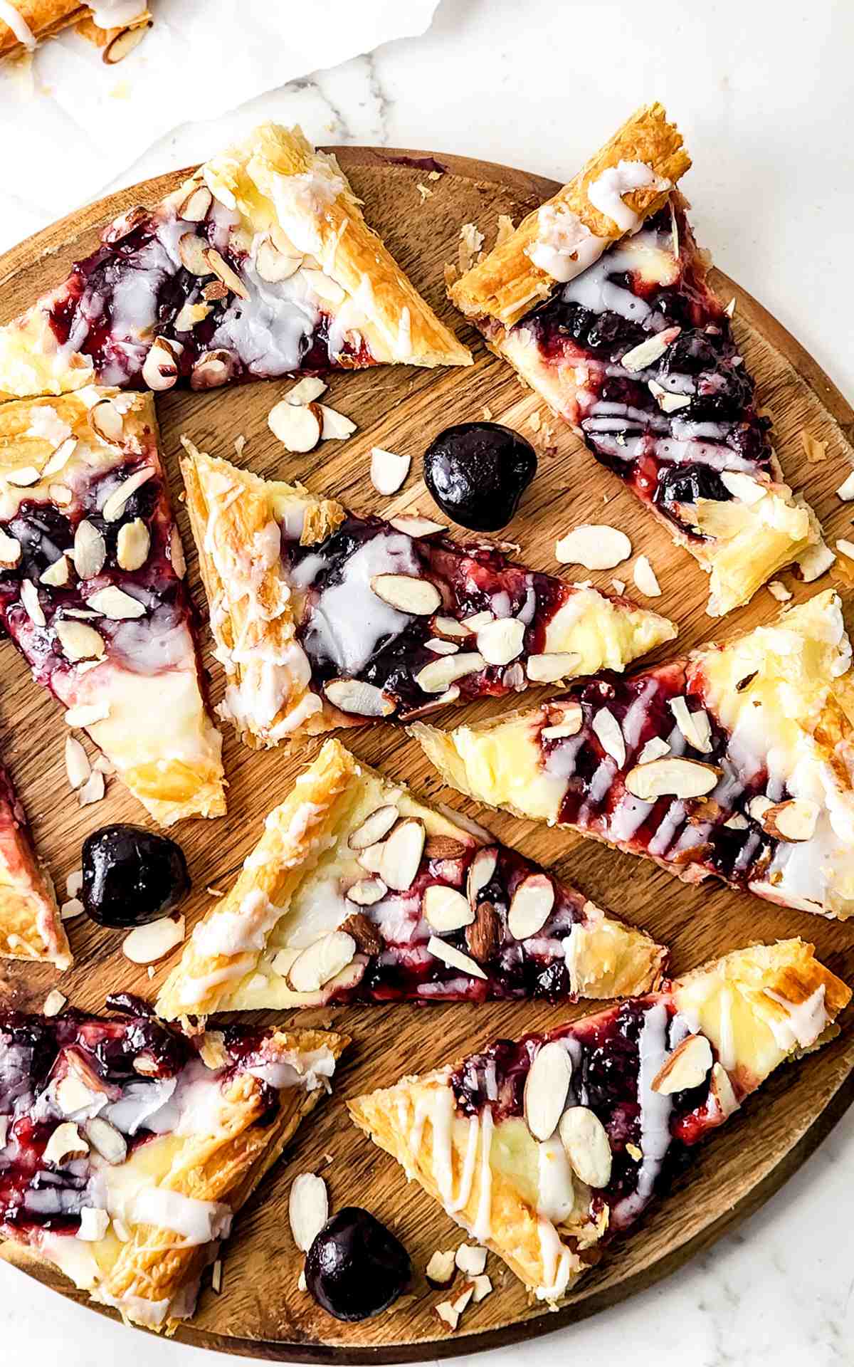 Sliced cherry cheese danishes made with puff pastry.
