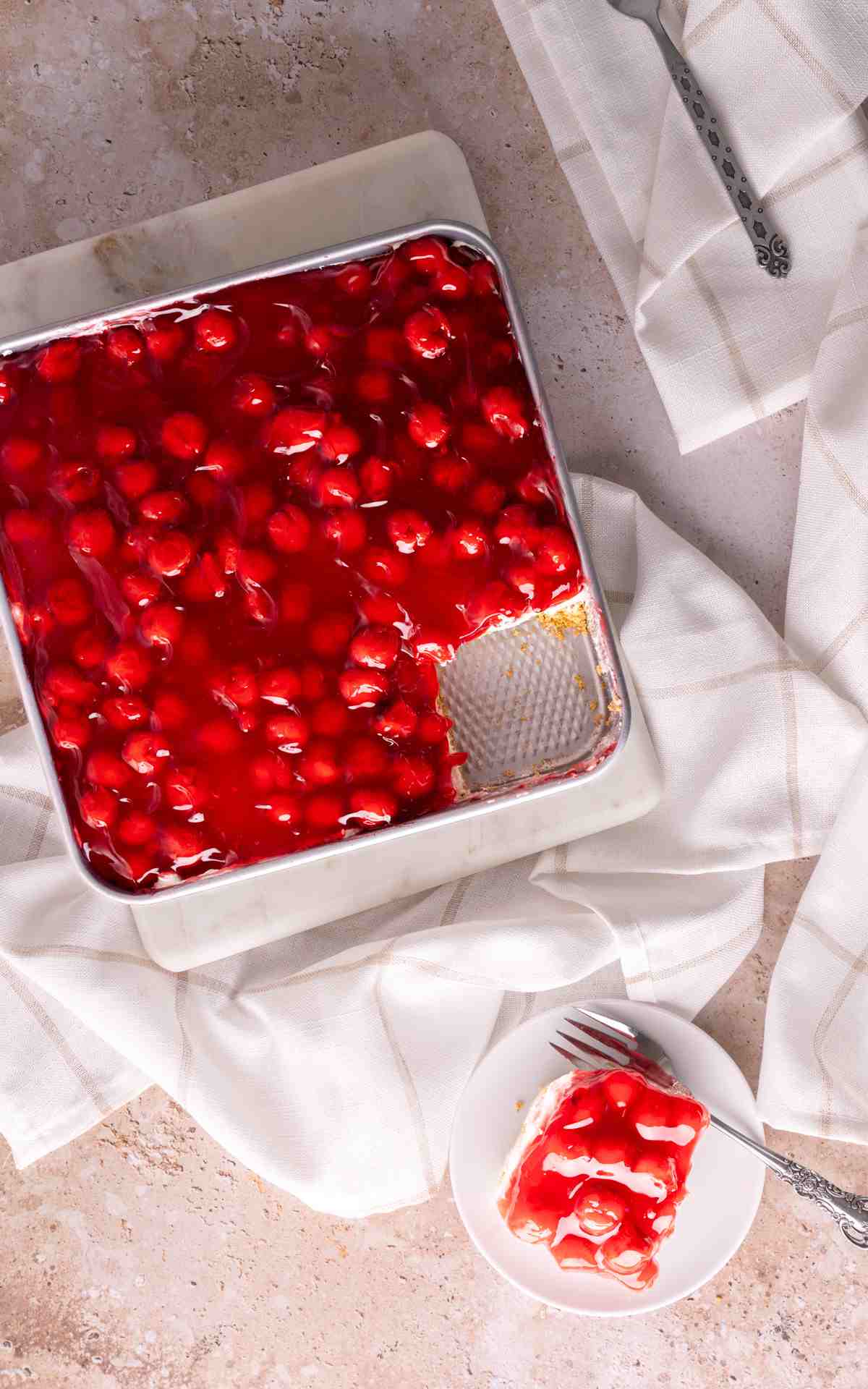Overhead photo of no bake cherry delight dessert with a plate.
