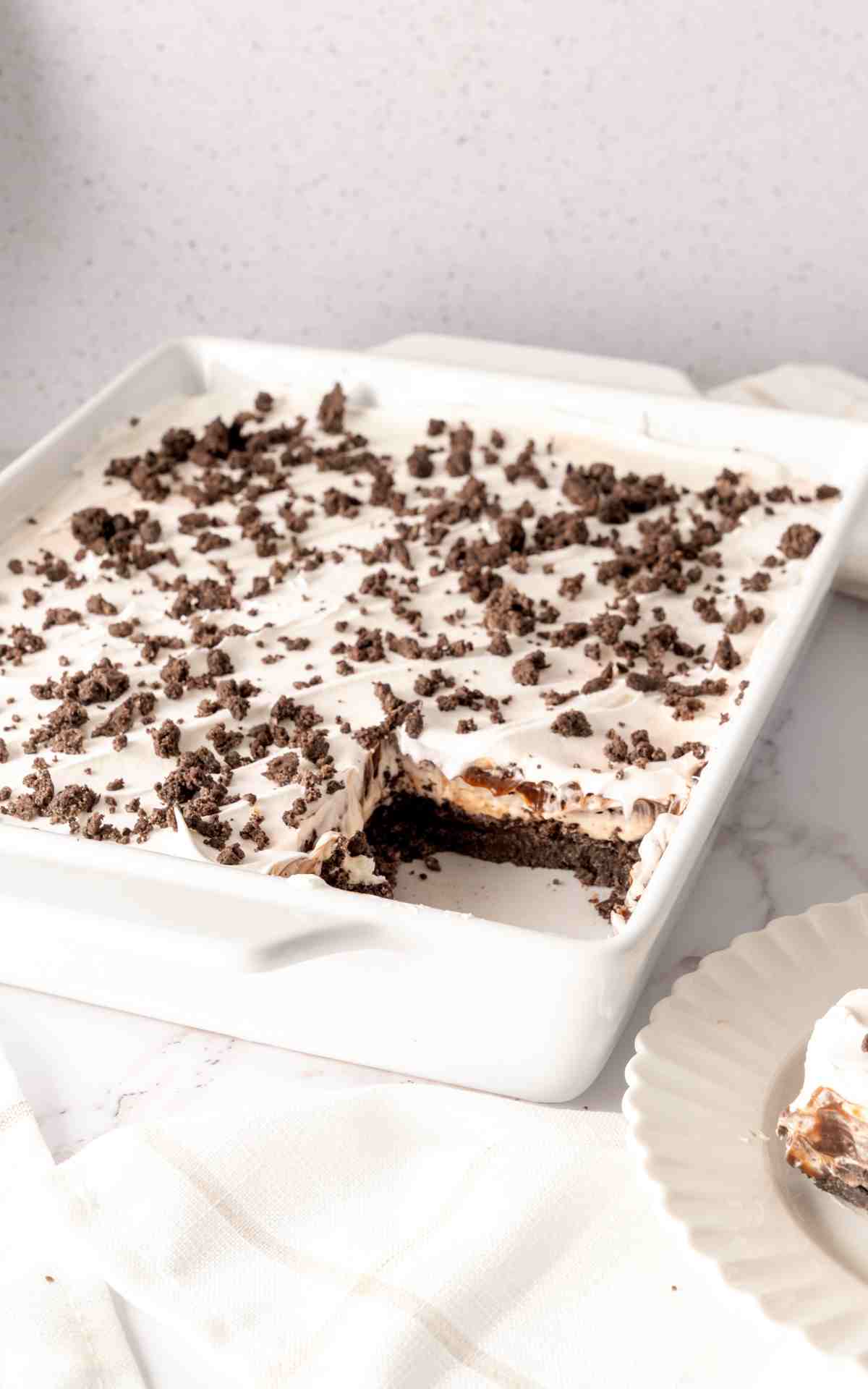 Side view of creamy layers of no bake chocolate dream topped with crumbled cookies.