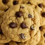 Close-up of chocolate chip cookies with a golden-brown crust and chocolate chips.