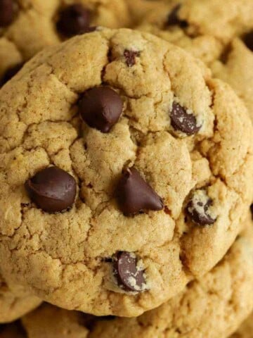 Close-up of chocolate chip cookies with a golden-brown crust and chocolate chips.