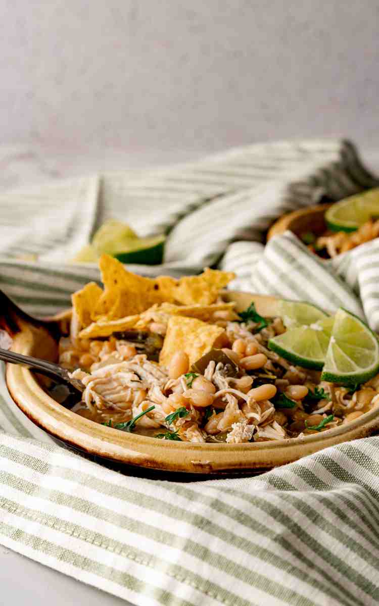 Tortilla chips crushed and topped on chicken chili made with salsa verde.