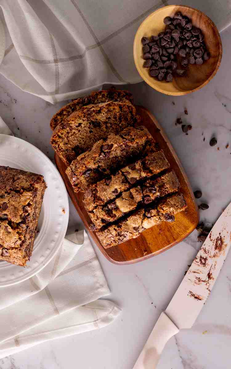 Freshly sliced zucchini chocolate chip bread on a cutting board.