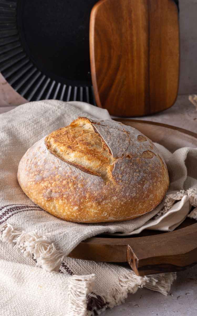 Golden brown Sourdough beginner bread on linen.