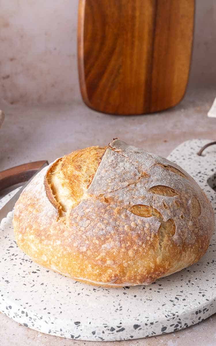 Side view of sourdough beginner recipe with a score and lifted ear.