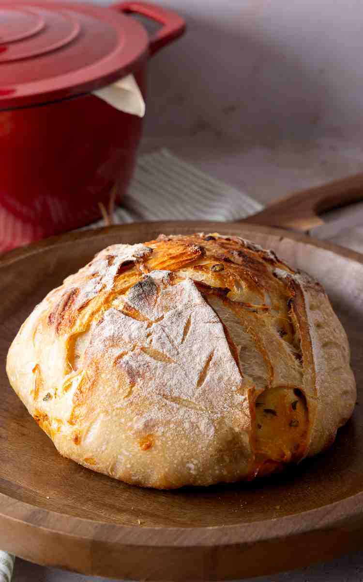 Side view of sourdough boule with decorative scoring.